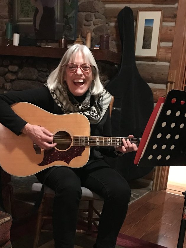Polly Conlon with her acoustic guitar